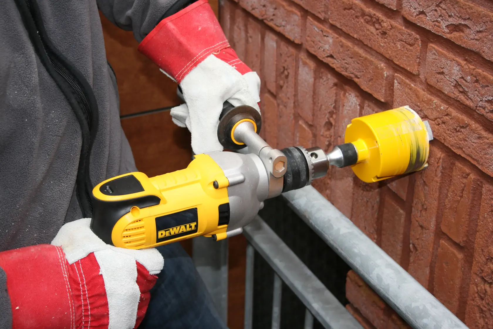 A DEWALT D21570K electric drill with a side handle and a yellow and black design.
